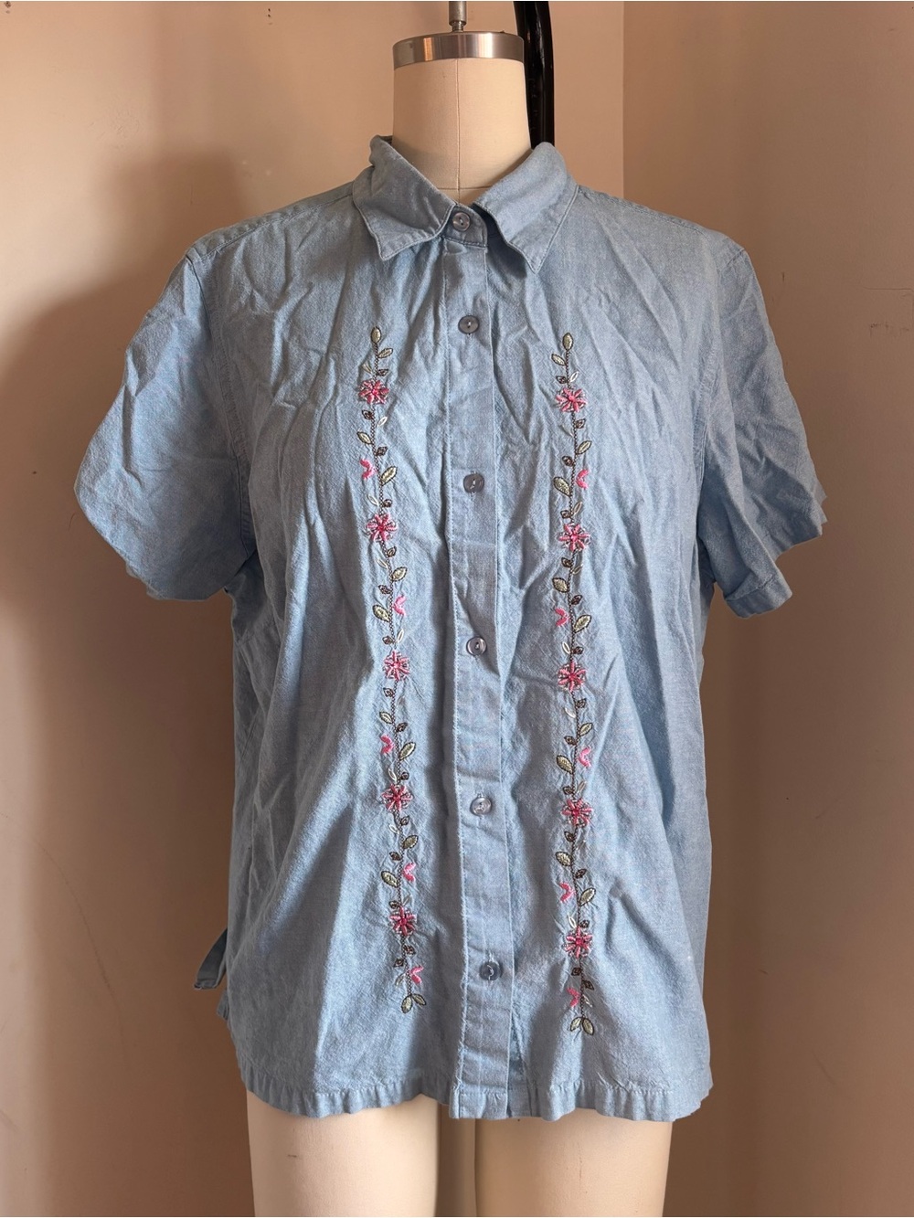 Blue embroidered button up shirt with pink floral embroidery down the front